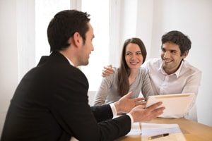 An image of a couple talking to a property manager