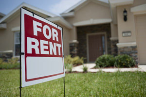 An image of a for rent sign in front of a house