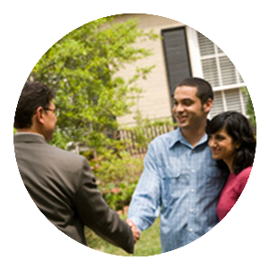A young couple shaking hands with a man in a suit in front of a home, similar to how PURE Property Management will welcome new tenants to your rental property covered by our Ronhert Park property management.